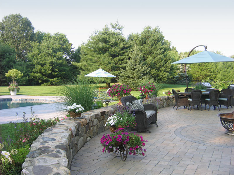 Patio and pool with stonewall and flowers