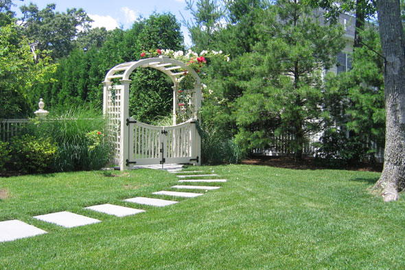 Lawn with walkway and gated arch