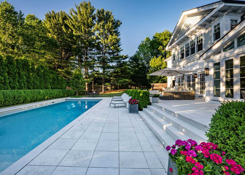 Outside of house with pool, pool deck, and flower boxes on the right